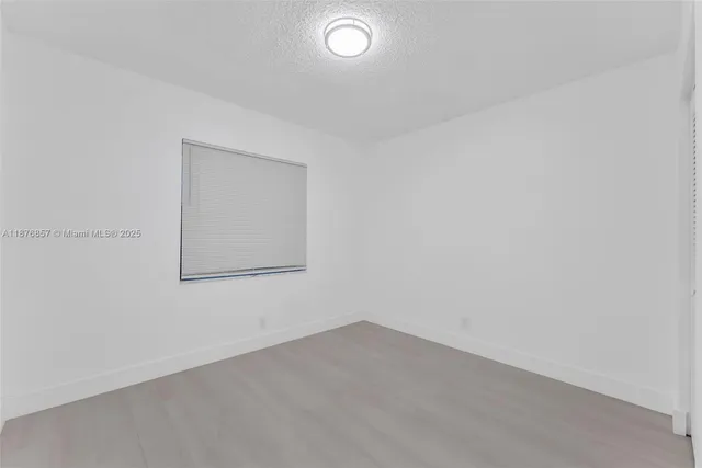 a bedroom with bed and a potted plant