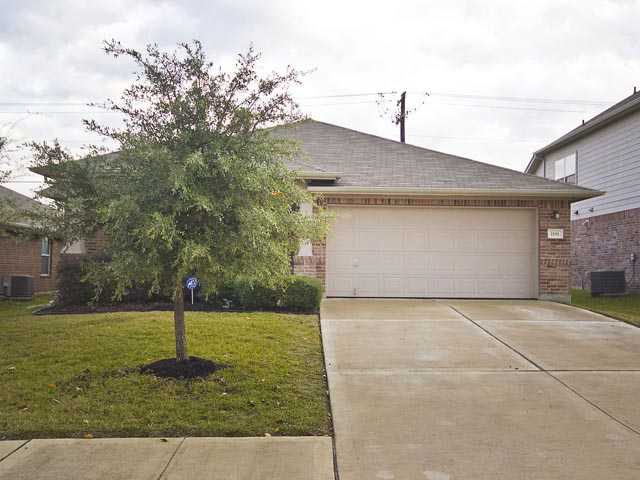 1191 Stone Rim Loop Buda, TX 78610 - Photo 1 of 1 a front view of a house with a yard