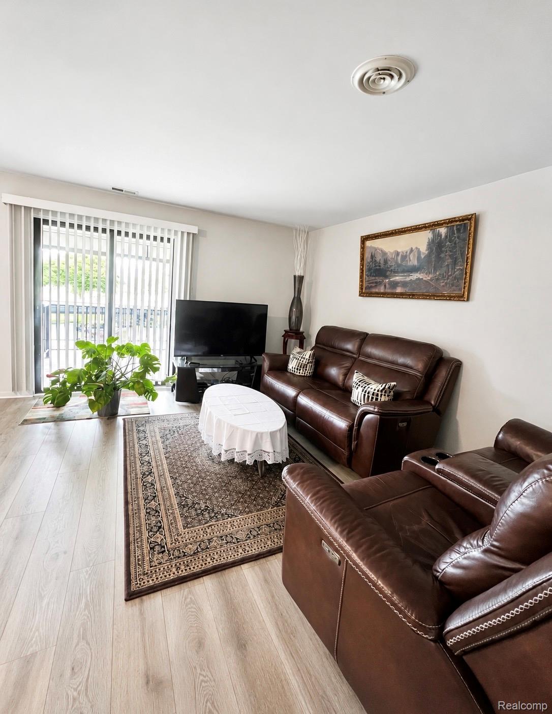 29838 Utica Road, Unit 25 Roseville, MI 48066 - Photo 3 of 15 Living area with light wood-style floors