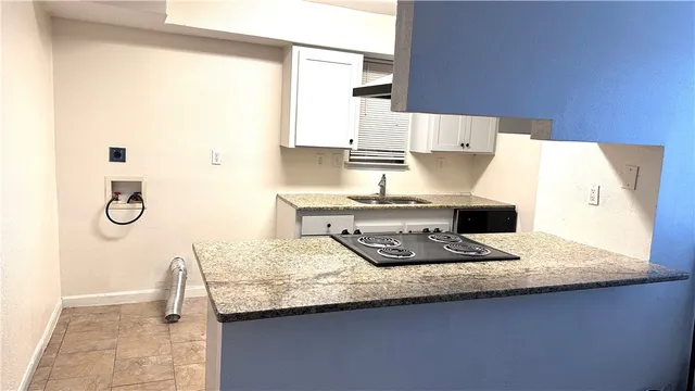 a kitchen with a sink a stove and a refrigerator