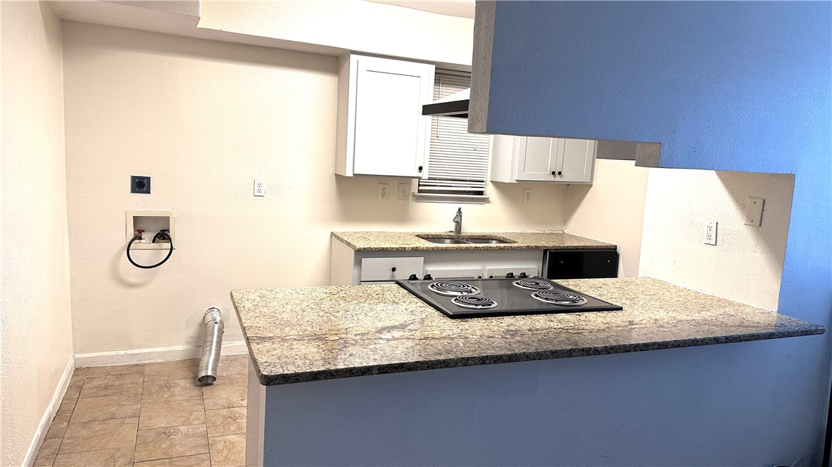 1932 Hidden Way Corpus Christi, TX 78412 - Photo 6 of 14 a kitchen with a sink a stove and a refrigerator