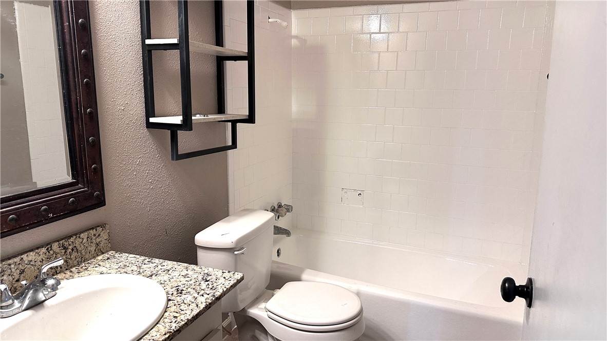 1932 Hidden Way Corpus Christi, TX 78412 - Photo 8 of 14 a white toilet sitting next to a bathroom sink