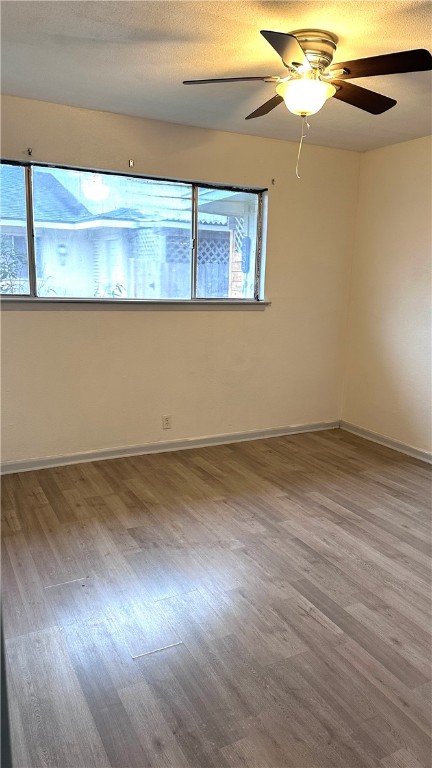 1932 Hidden Way Corpus Christi, TX 78412 - Photo 9 of 14 an empty room with wooden floor and windows