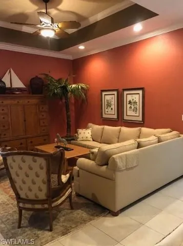 a living room with furniture and chandelier