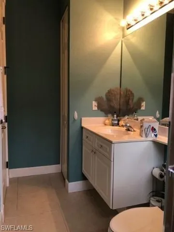 a bathroom with a sink vanity and toilet