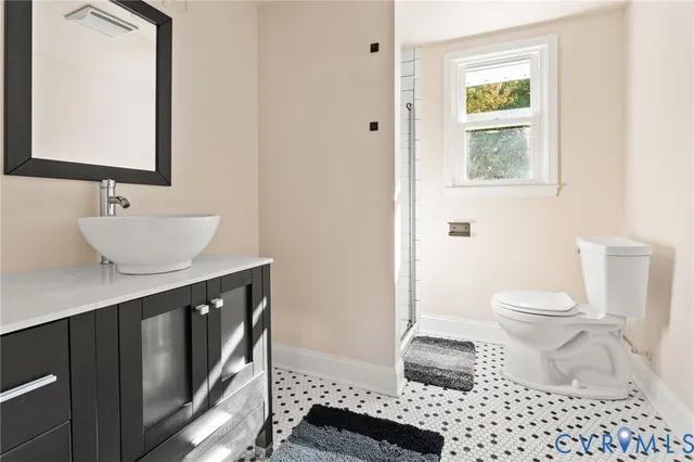 a bathroom with a sink toilet a mirror and shower