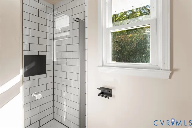a bathroom with a shower and a window