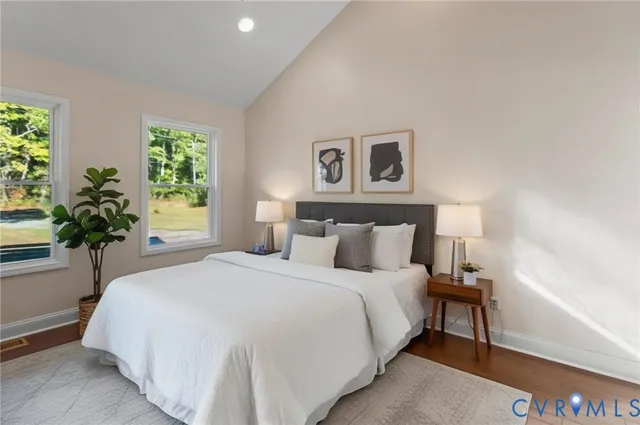 a bedroom with a bed and a potted plant