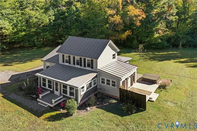 an aerial view of a house with pool and ocean view