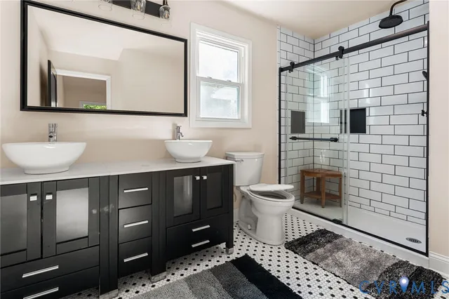 a bathroom with a sink toilet and mirror