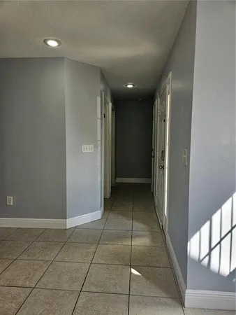 a view of hallway with a shower and a sink