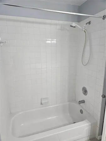 a bathroom with a shower and a bath tub