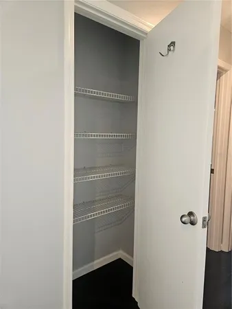 a view of walk in closet with empty racks