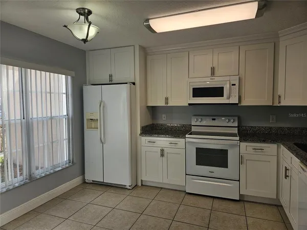 a kitchen with cabinets stainless steel appliances and a counter space