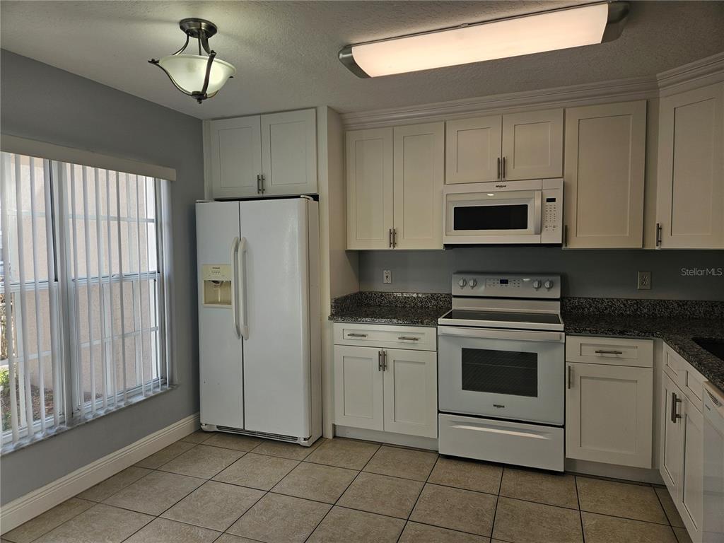 2321 Water View Loop Kissimmee, FL 34743 - Photo 3 of 41 a kitchen with cabinets stainless steel appliances and a counter space