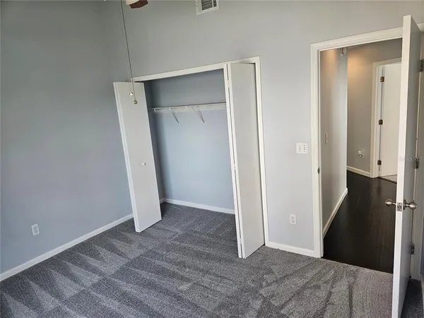 a view of an empty room with a fan