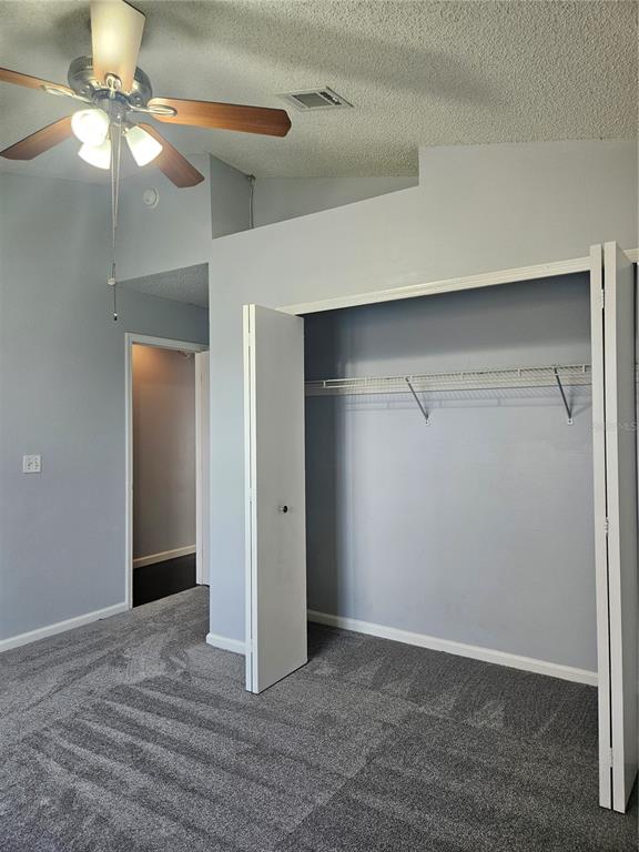2321 Water View Loop Kissimmee, FL 34743 - Photo 36 of 41 a view of an empty room with a ceiling fan