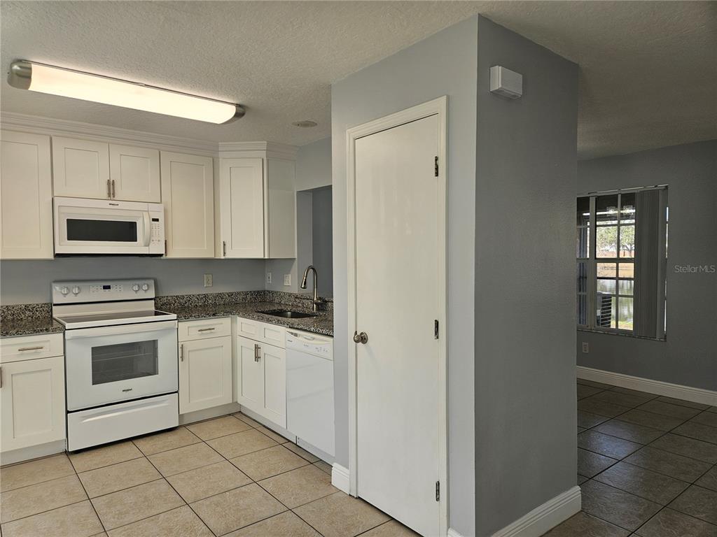 2321 Water View Loop Kissimmee, FL 34743 - Photo 4 of 41 a kitchen with cabinets stainless steel appliances and sink