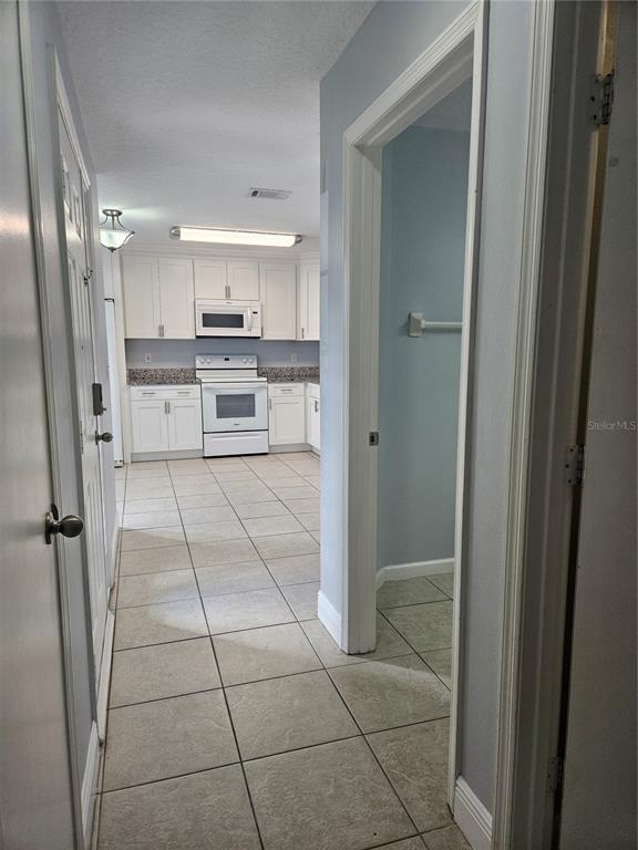2321 Water View Loop Kissimmee, FL 34743 - Photo 5 of 41 a kitchen with stainless steel appliances granite countertop a refrigerator and a sink
