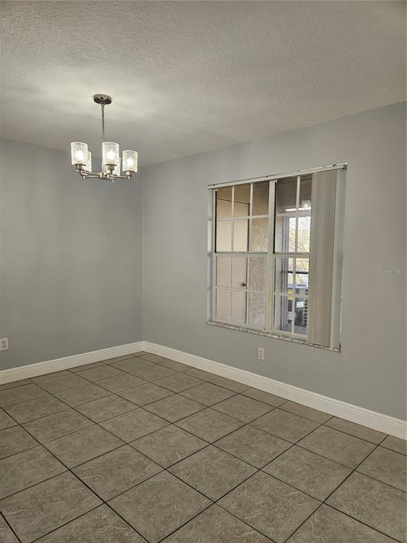 2321 Water View Loop Kissimmee, FL 34743 - Photo 6 of 41 an empty room with wooden floor and windows