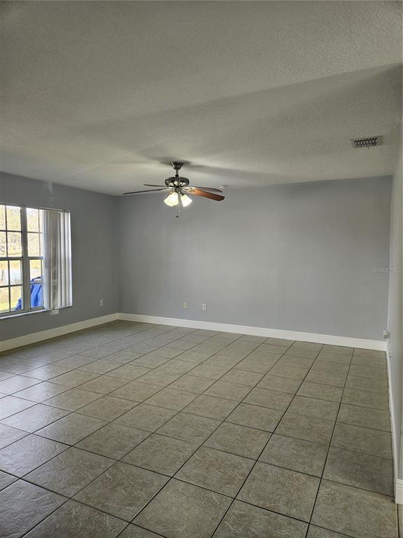2321 Water View Loop Kissimmee, FL 34743 - Photo 8 of 41 a view of an empty room with a window