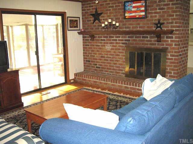 8809 Katharina Court Raleigh, NC 27613 - Photo 5 of 12 a living room with a rug floor and a fireplace