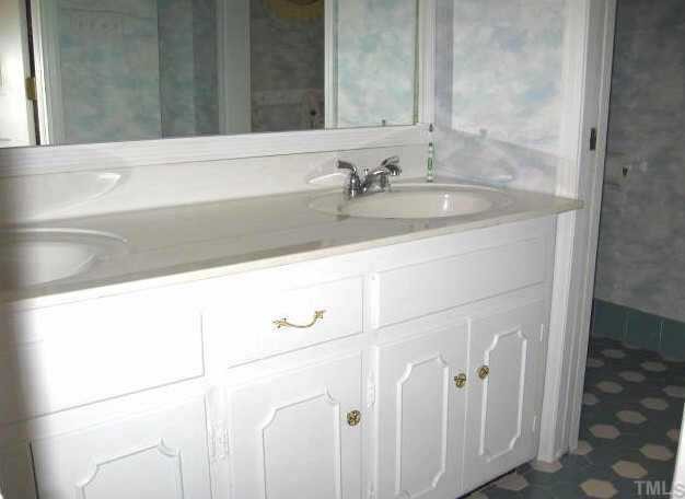 8809 Katharina Court Raleigh, NC 27613 - Photo 10 of 12 a bathroom with a sink and a mirror