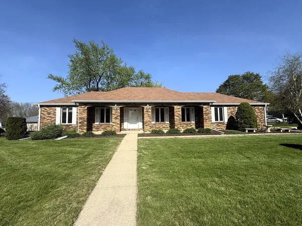 a front view of a house with yard patio and green space