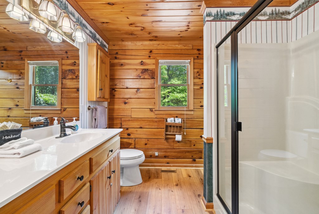1600 My Mountain Road Morganton, GA 30560 - Photo 14 of 50 a bathroom with a double vanity sink toilet and shower