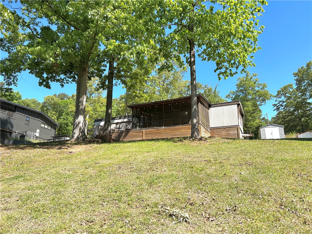 43 Sunset Cove Road Abbeville, SC 29620 - Photo 2 of 41 This property features a charming screened porch, perfect for enjoying the outdoors.