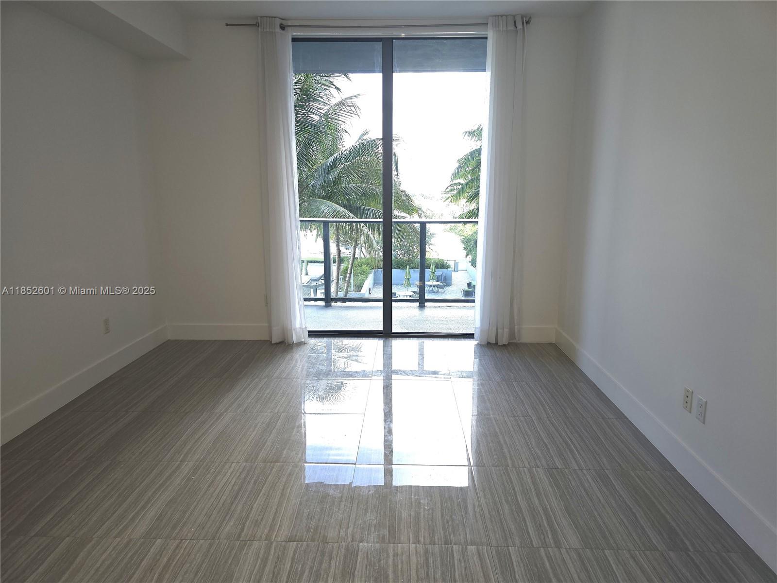 2960 Northeast 207th Street, Unit 713 Aventura, FL 33180 - Photo 11 of 33 wooden floor in an empty room with a window