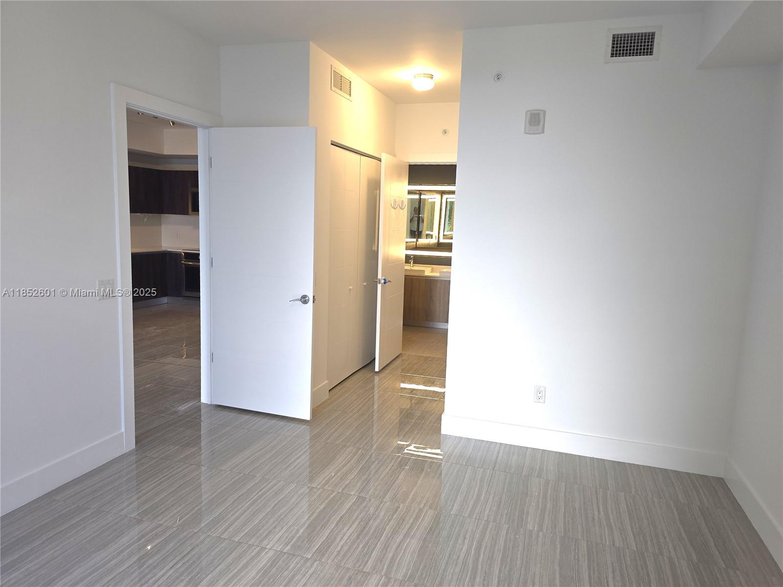 2960 Northeast 207th Street, Unit 713 Aventura, FL 33180 - Photo 12 of 33 an empty room with wooden floor and windows