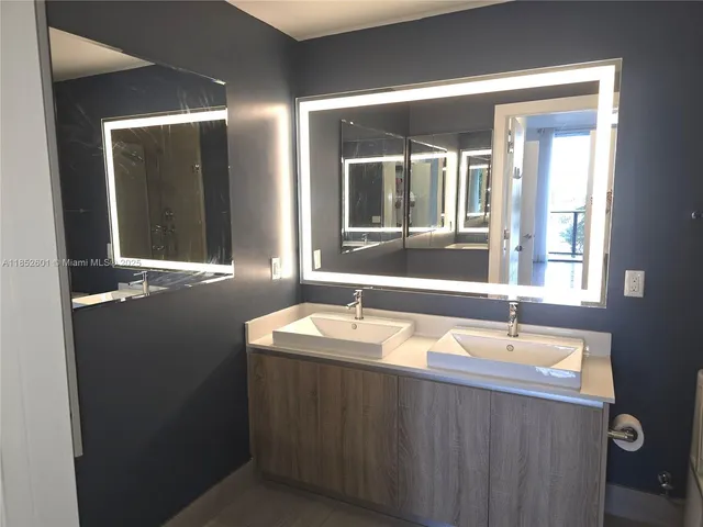 a white toilet sitting next to a shower