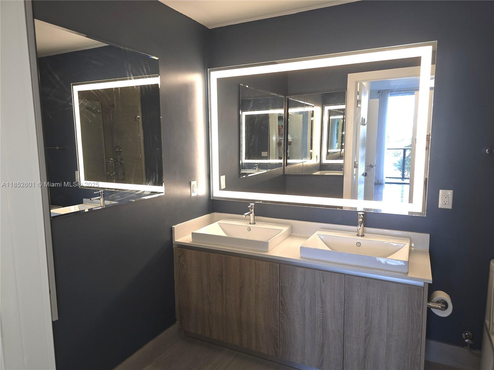 2960 Northeast 207th Street, Unit 713 Aventura, FL 33180 - Photo 13 of 33 a bathroom with a sink and a mirror