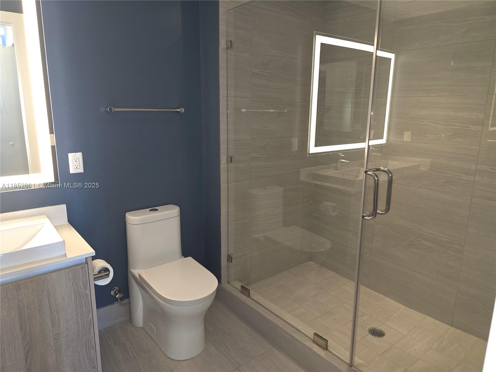 2960 Northeast 207th Street, Unit 713 Aventura, FL 33180 - Photo 14 of 33 a white toilet sitting next to a shower