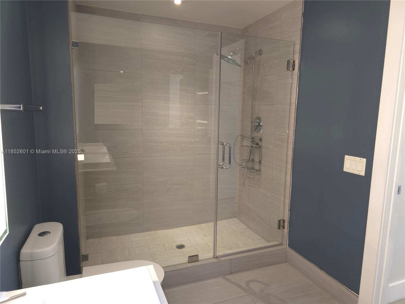 2960 Northeast 207th Street, Unit 713 Aventura, FL 33180 - Photo 15 of 33 a bathroom with a shower and toilet
