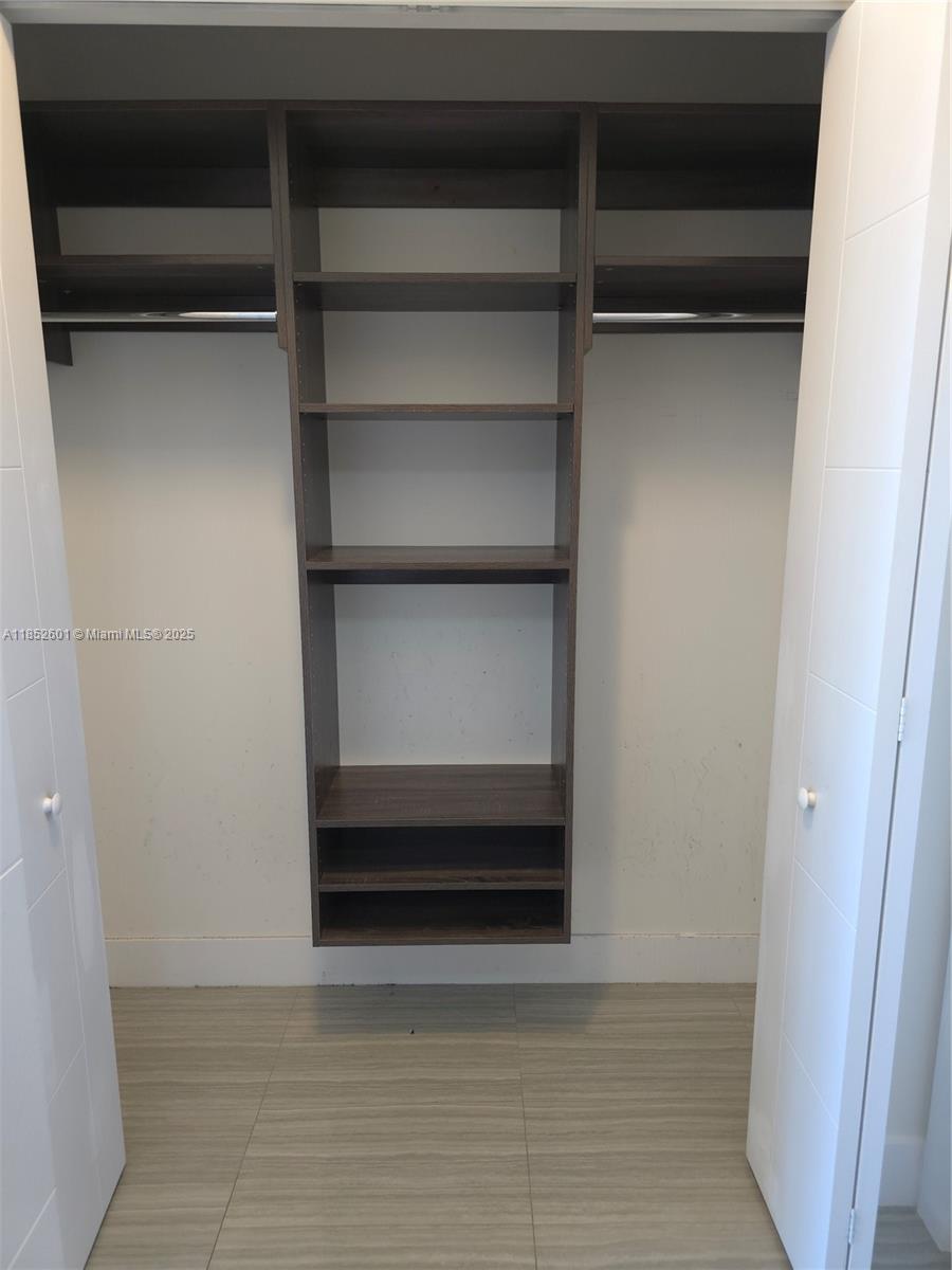 2960 Northeast 207th Street, Unit 713 Aventura, FL 33180 - Photo 18 of 33 a view of walk in closet with empty racks