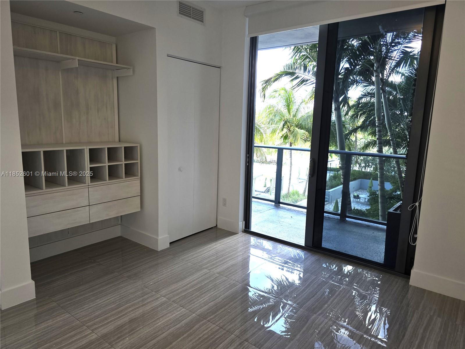 2960 Northeast 207th Street, Unit 713 Aventura, FL 33180 - Photo 21 of 33 a view of empty room with wooden floor and fan