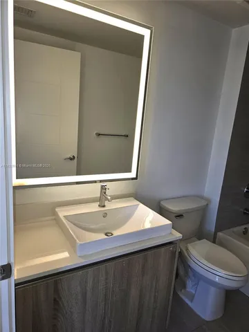a bathroom with a sink a toilet and bathtub