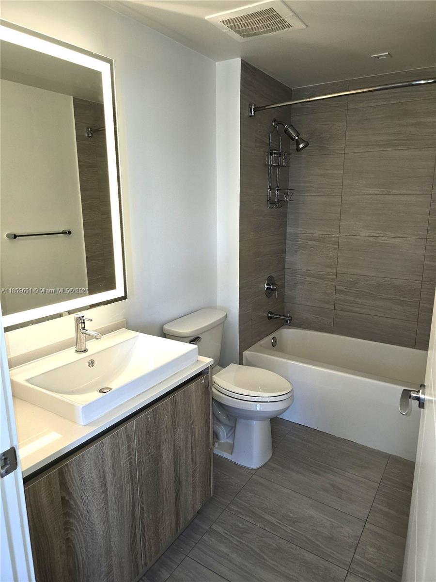 2960 Northeast 207th Street, Unit 713 Aventura, FL 33180 - Photo 24 of 33 a bathroom with a sink a toilet and bathtub