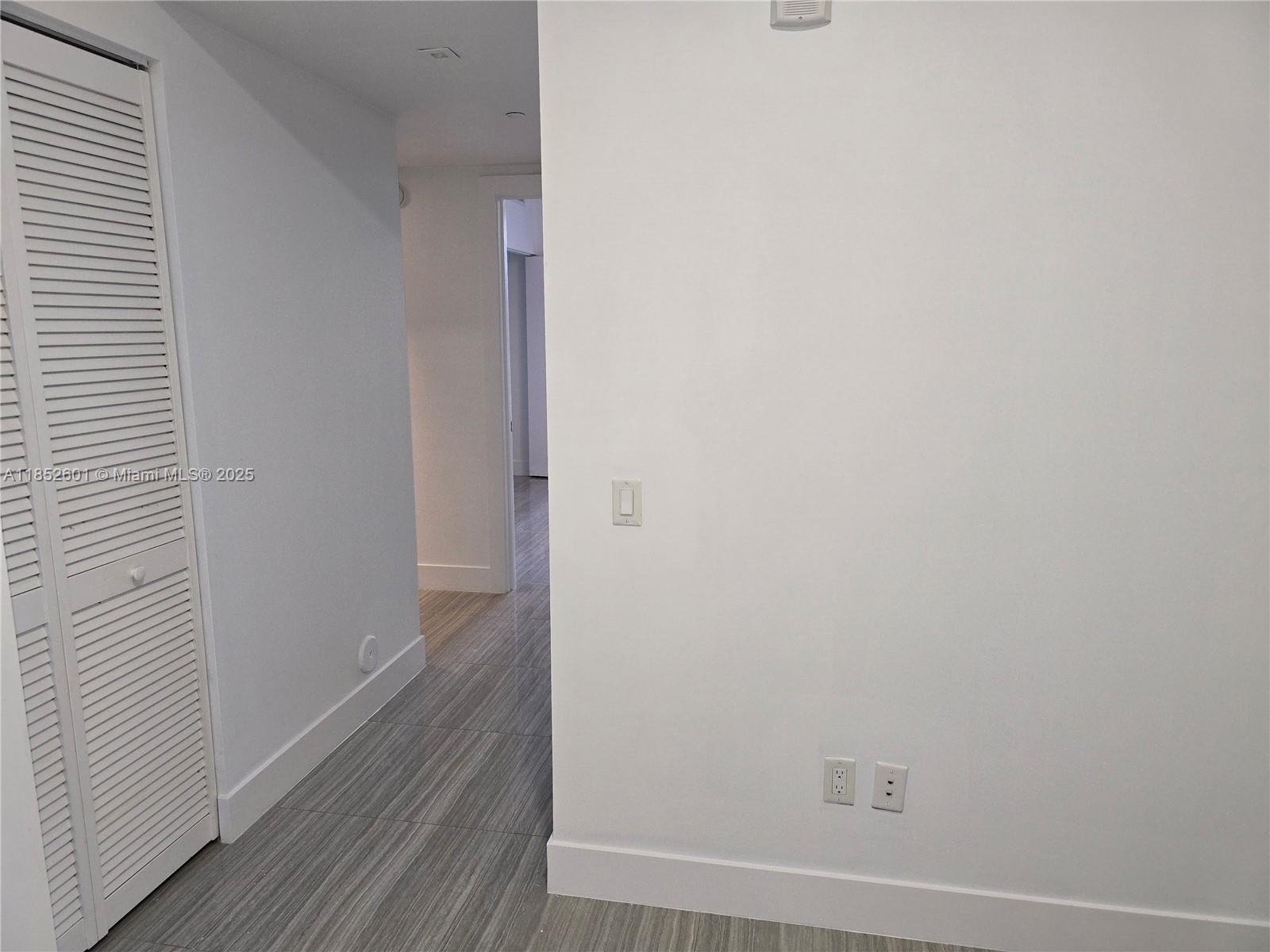 2960 Northeast 207th Street, Unit 713 Aventura, FL 33180 - Photo 26 of 33 a view of a hallway with wooden floor