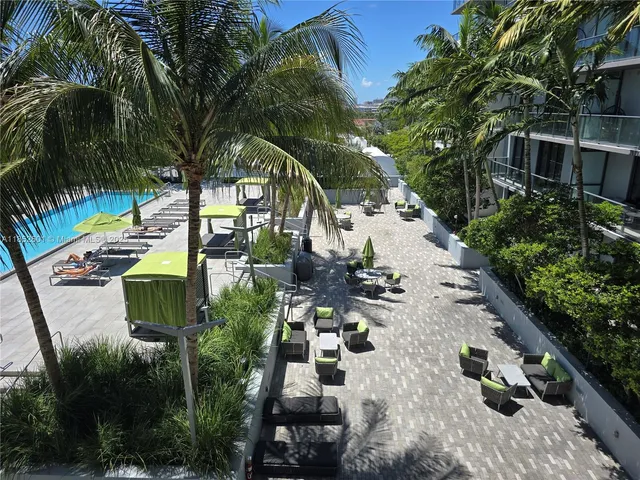 an aerial view of a house with a yard and potted plants