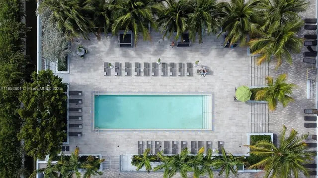 a living room with furniture kitchen view and a flat screen tv
