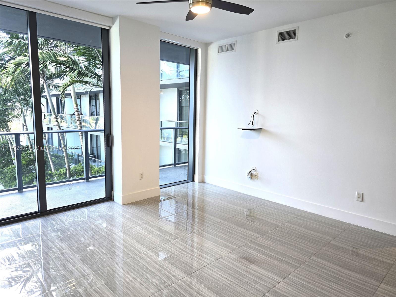 2960 Northeast 207th Street, Unit 713 Aventura, FL 33180 - Photo 4 of 33 a view of empty room with wooden floor and fan
