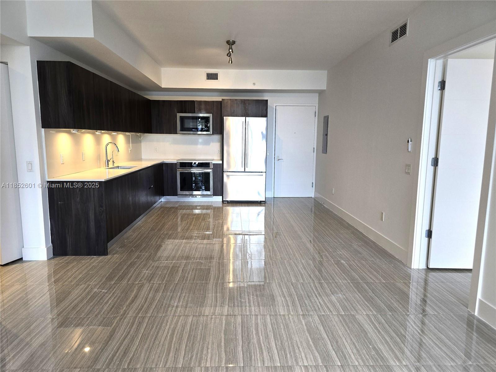 2960 Northeast 207th Street, Unit 713 Aventura, FL 33180 - Photo 6 of 33 a view of kitchen with furniture and wooden floor