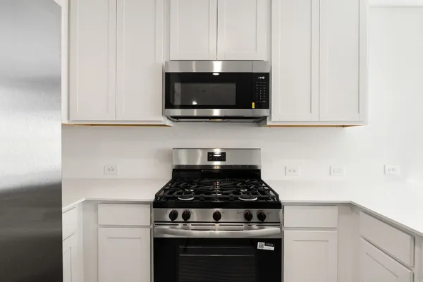 a stove top oven sitting inside of a kitchen