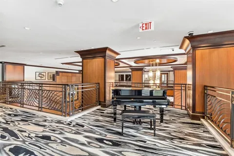 a view of a dining room with furniture and windows