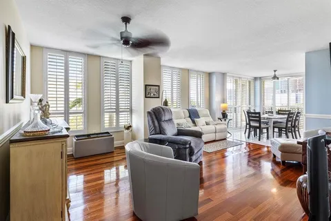 a dining room with furniture and wooden floor