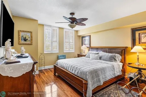 a bathroom with a granite countertop sink a toilet and a mirror