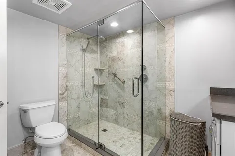 a bathroom with a glass shower door